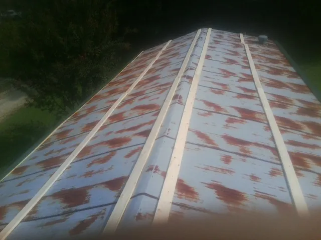 Rusted metal roof panels with new wood purlins before replacement — Storm Damage Roof Repair in Tomball by Roofing Brothers
